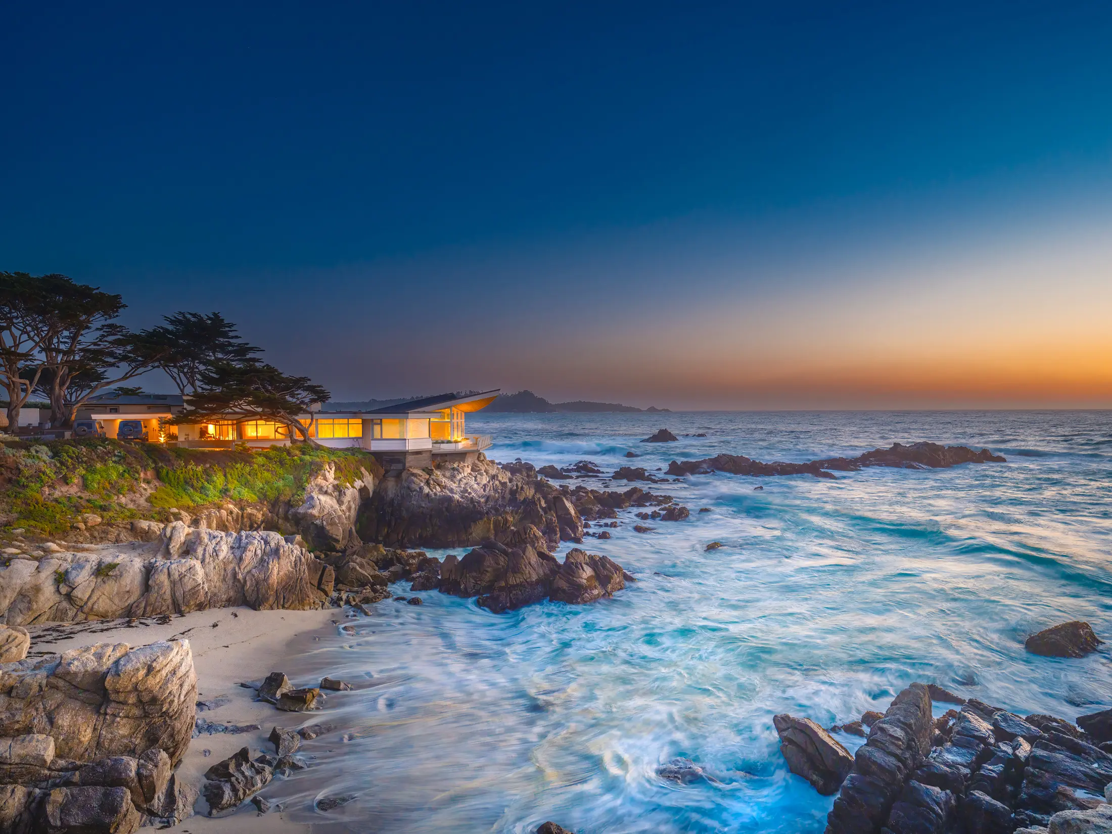 Oceanfront home at dusk on Carmel Point, Carmel-by-the-Sea